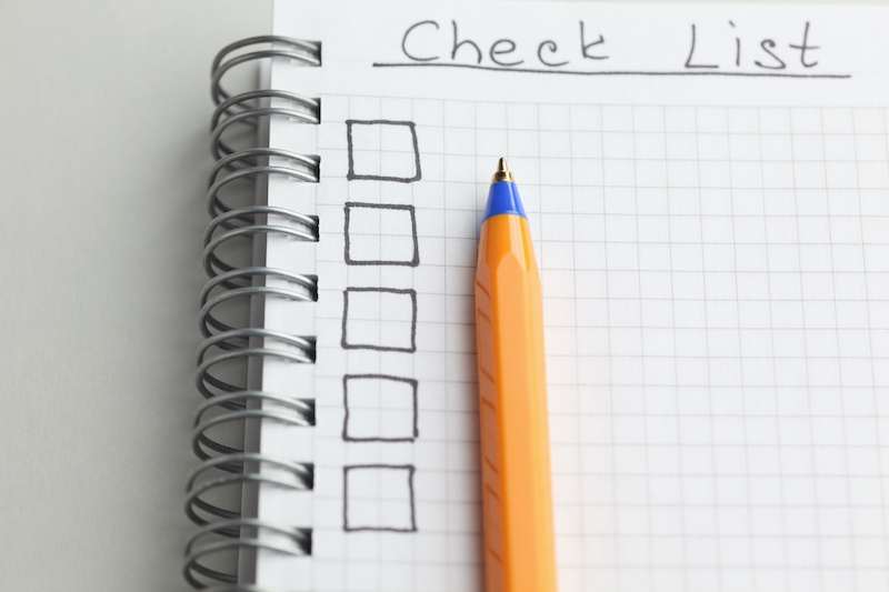 A handwritten checklist for noting what top outplacement services offer.