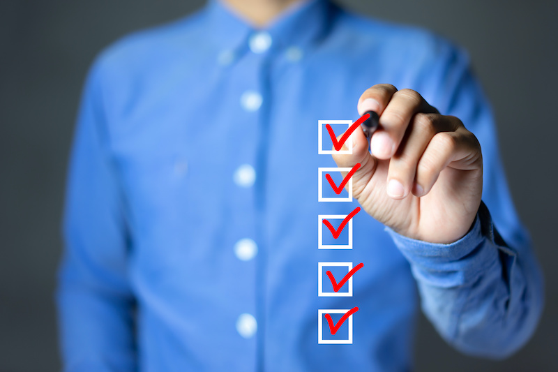A manager ticks a transparent checkbox, signifying a step taken on the employee termination checklist