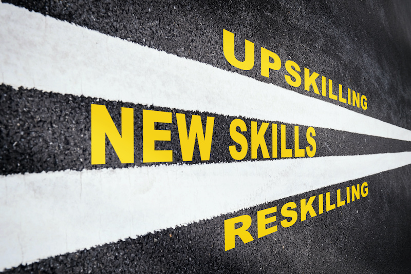 Double lines on a road indicate a path to new skills by upskilling and reskilling.