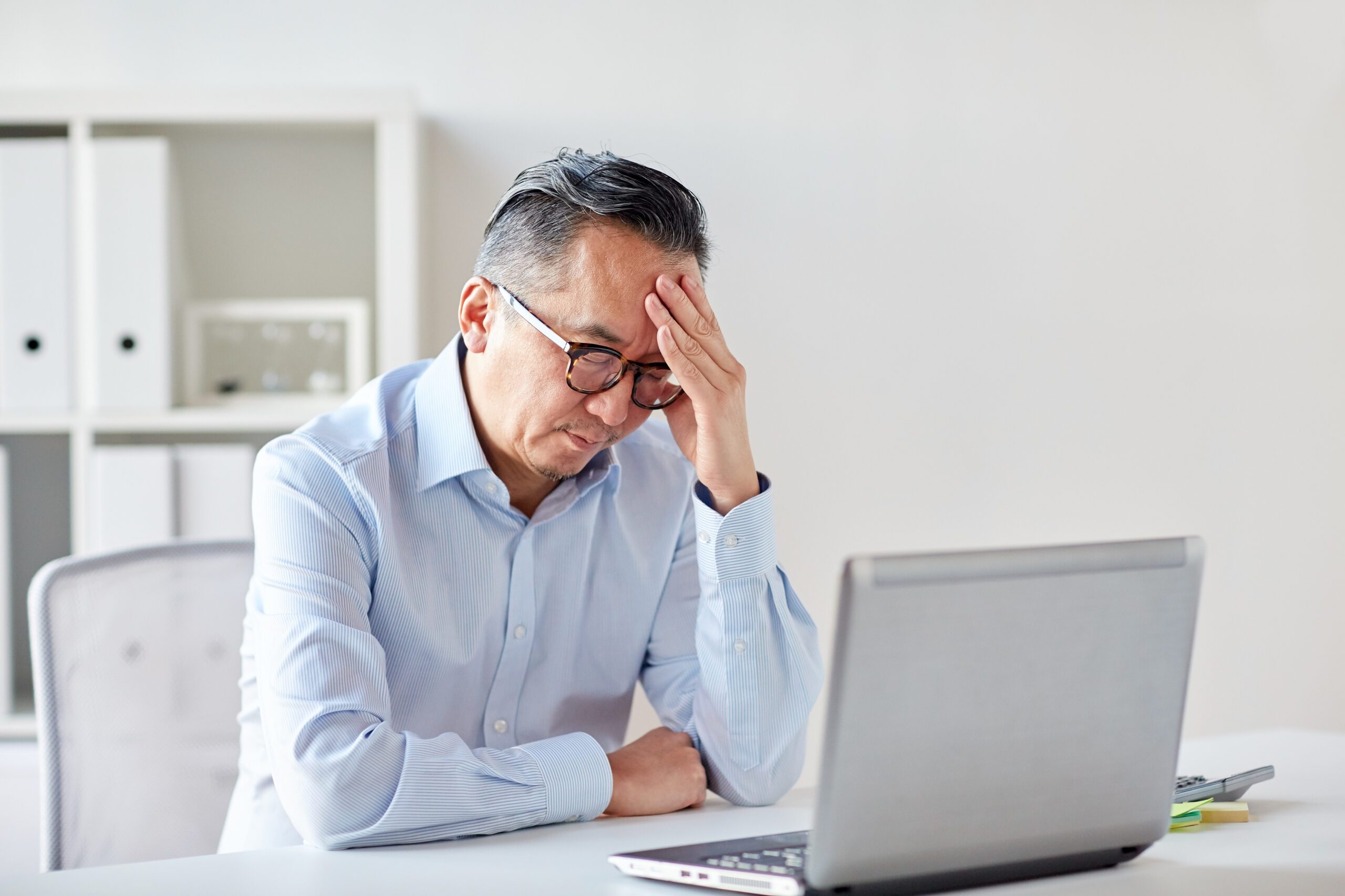 Man stressed and over-worked highlighting importance of employee resilience and well-being