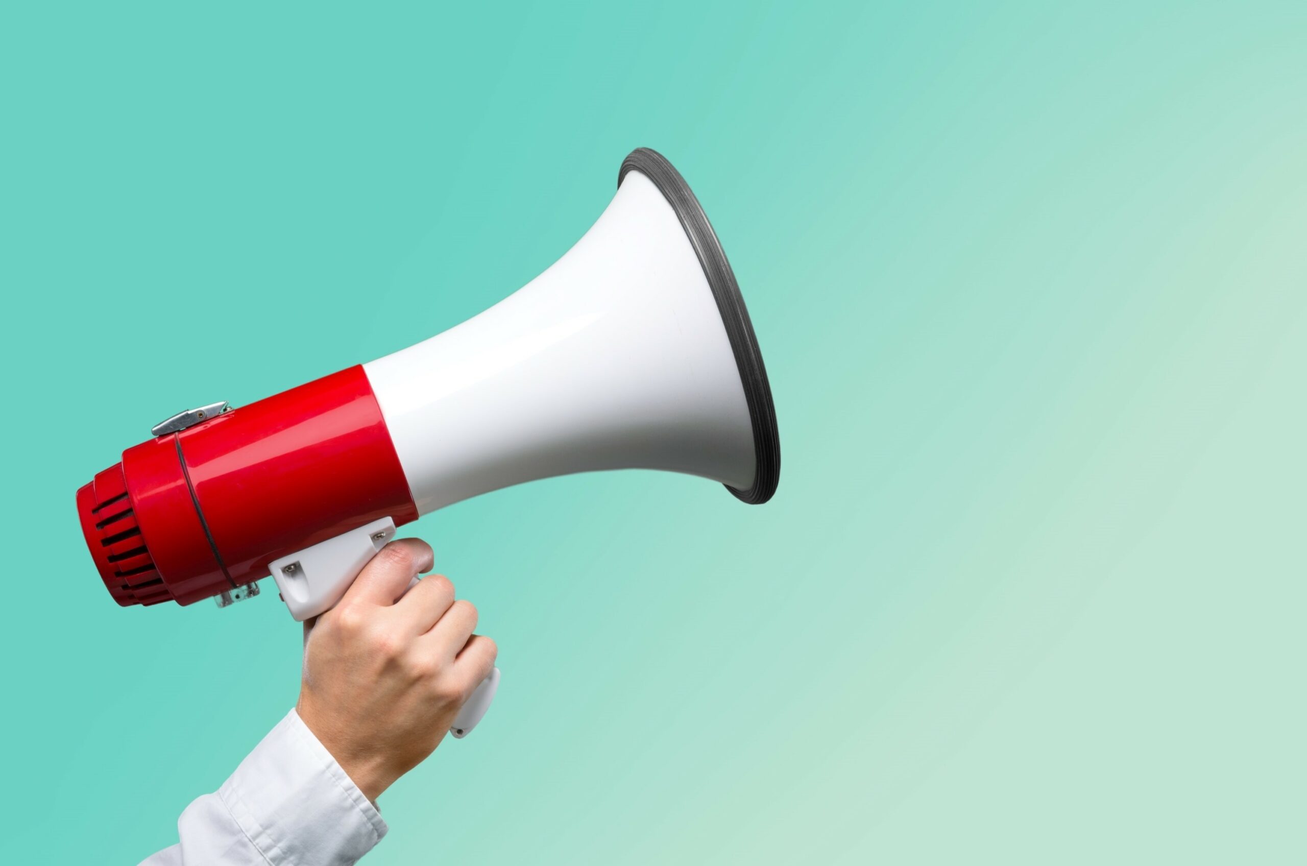 Close-up Human Hand with Megaphone on background