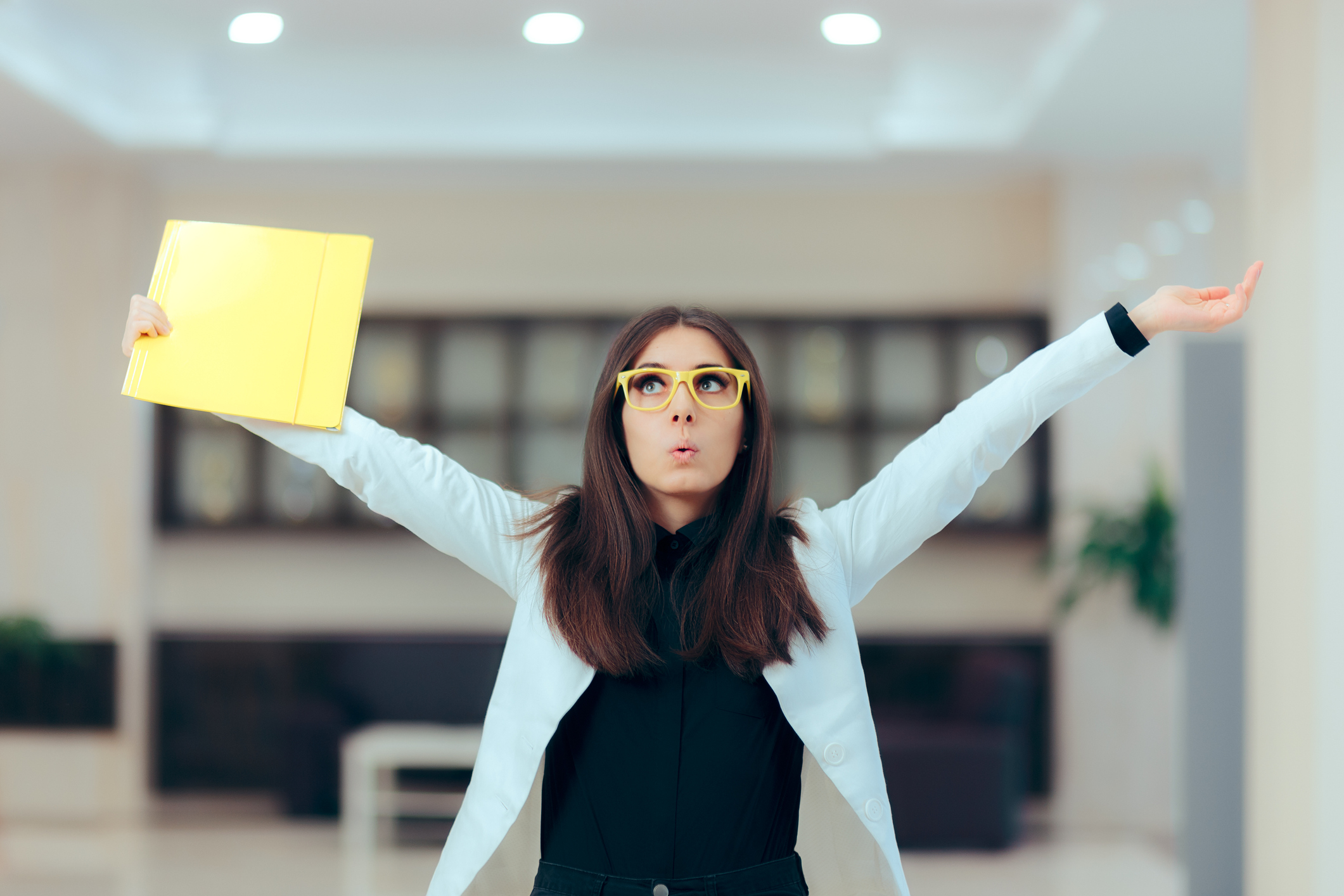 Excited Business Women Holding Up Important Documents