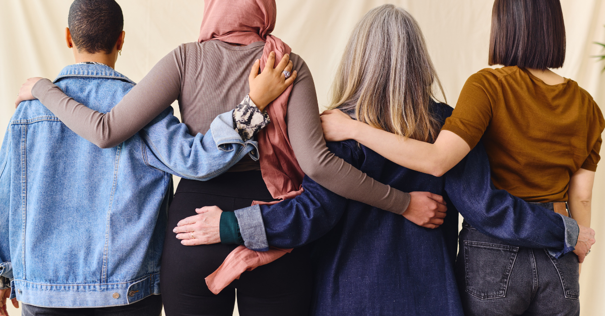 Rear view shot of a diverse group of women hugging each other