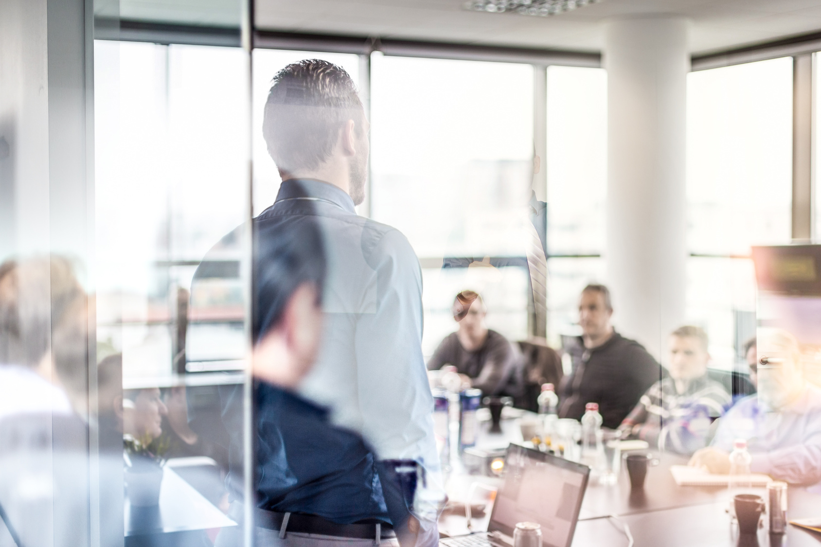 A young Black woman leads her team in a project meeting