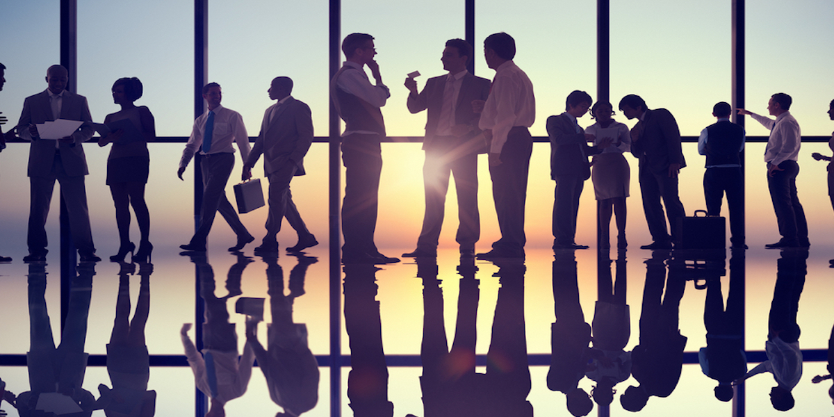 A young Black woman leads her team in a project meeting