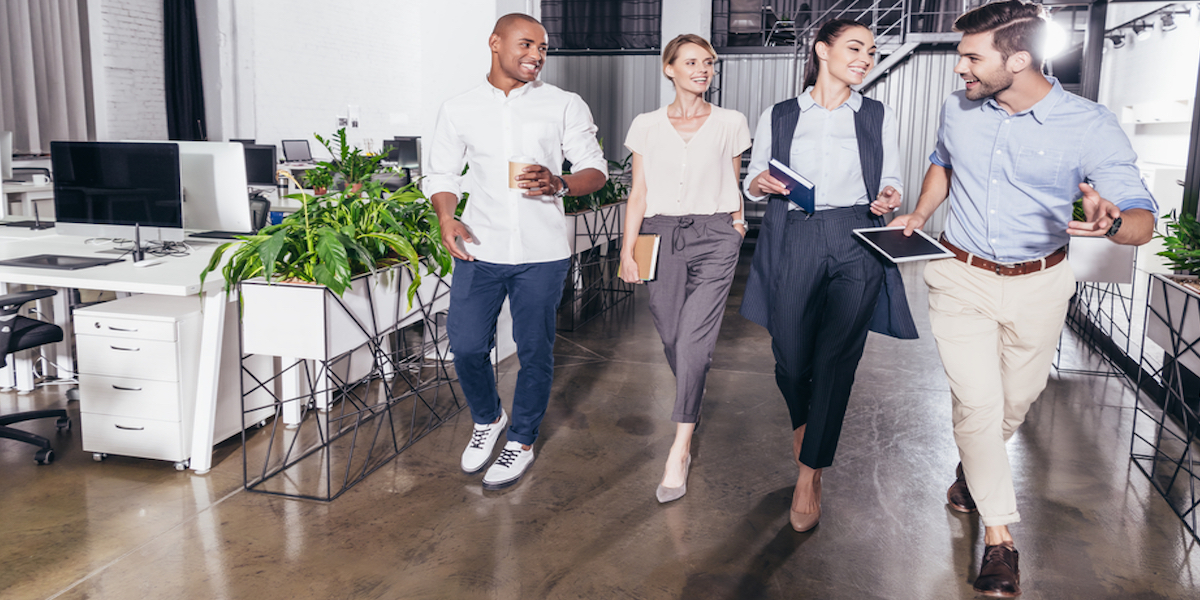 A young Black woman leads her team in a project meeting