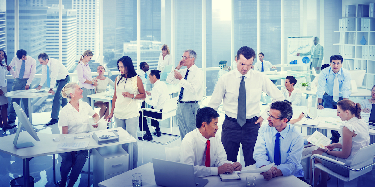 A young Black woman leads her team in a project meeting