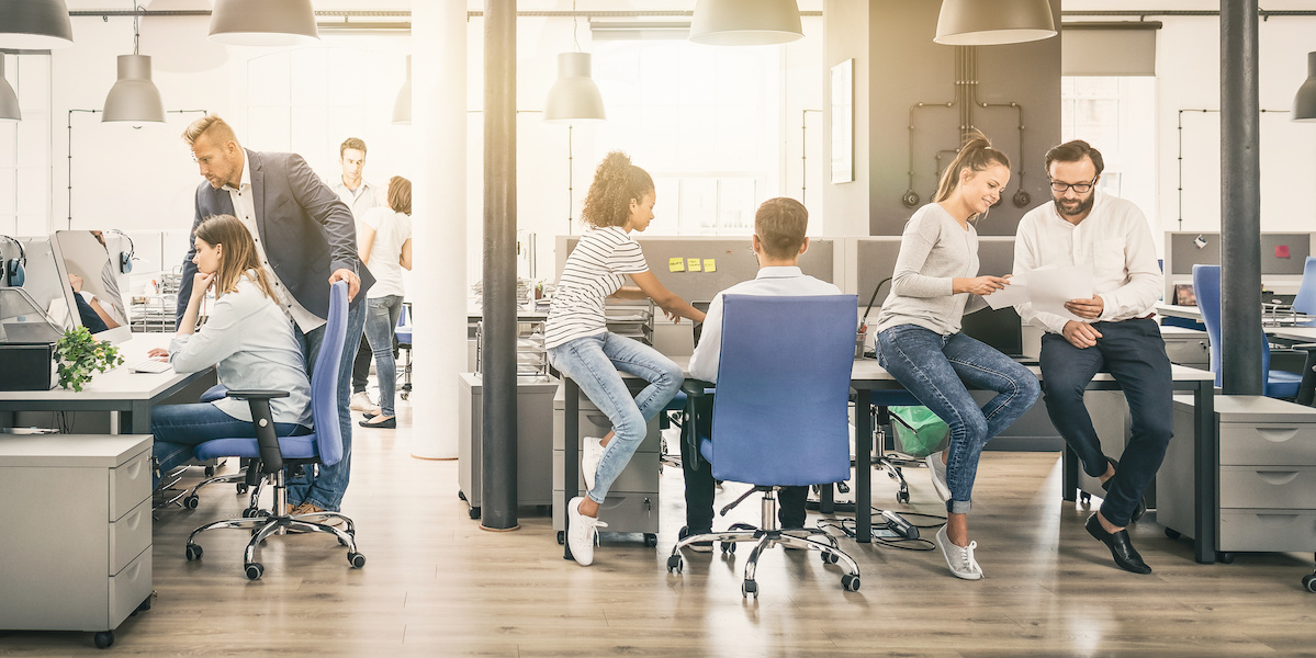 A young Black woman leads her team in a project meeting