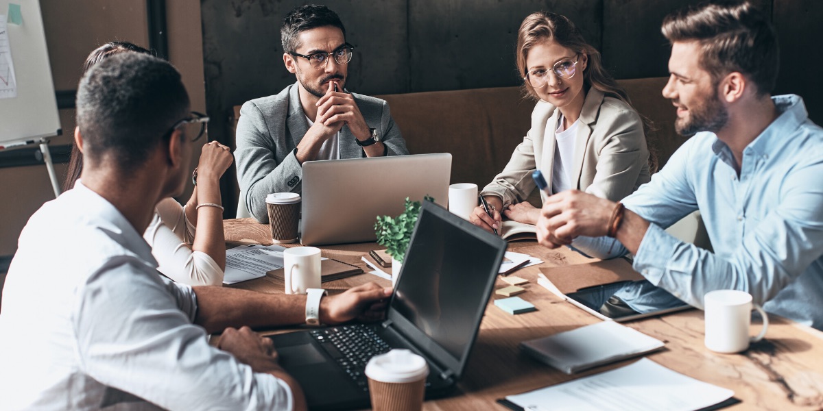 A young Black woman leads her team in a project meeting