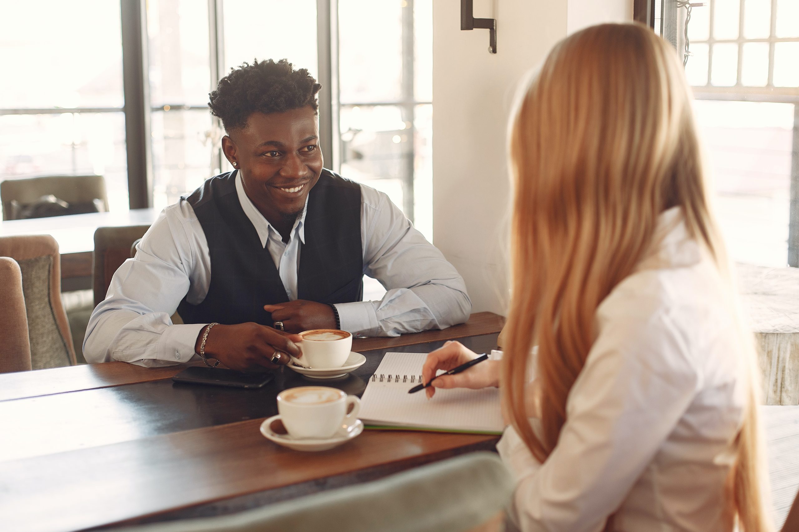 A young Black woman leads her team in a project meeting