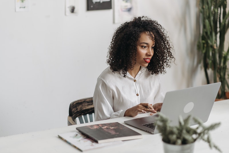 A young Black woman leads her team in a project meeting