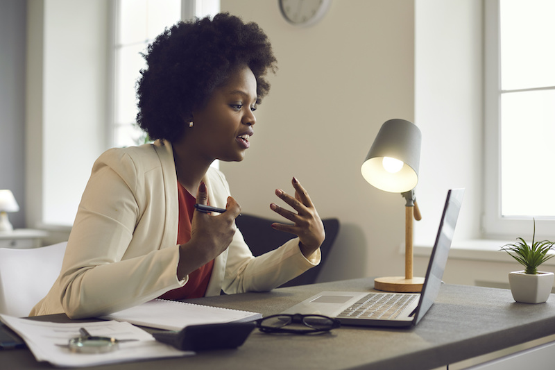 A young Black woman leads her team in a project meeting