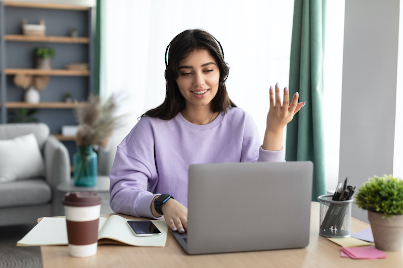 A young Black woman leads her team in a project meeting