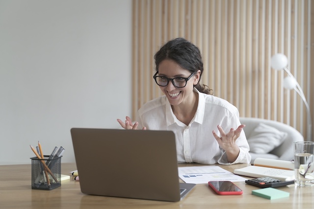 A young Black woman leads her team in a project meeting