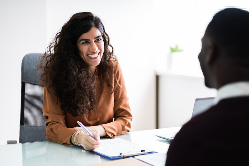 A young Black woman leads her team in a project meeting