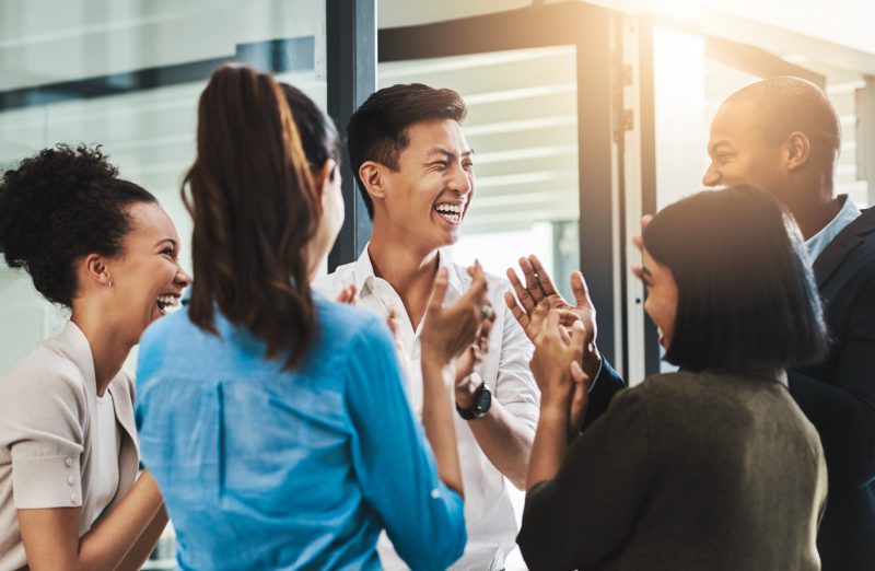 A young Black woman leads her team in a project meeting