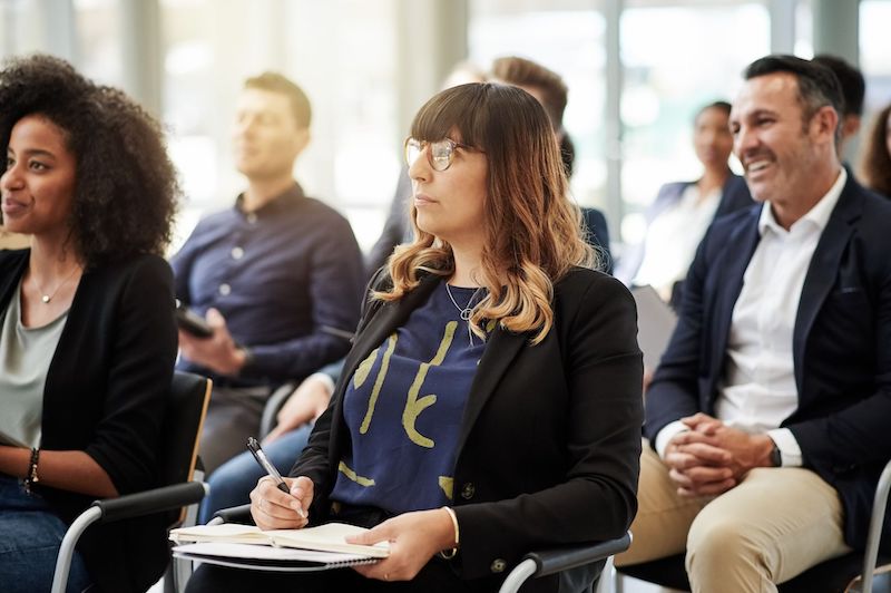 A young Black woman leads her team in a project meeting