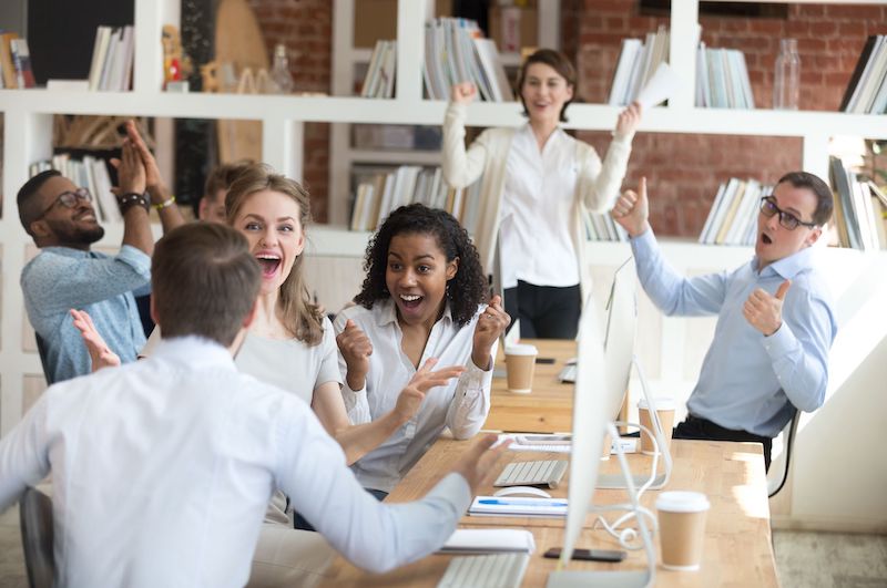 A young Black woman leads her team in a project meeting