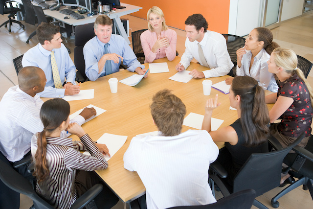 Employer holds a group meeting to communicate reorganization with employees.