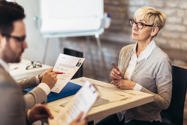 Hiring managers look for ways to reduce bias in hiring, as they interview a woman in her 60s.