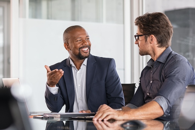 A Black male manager has career development conversations with his male employee