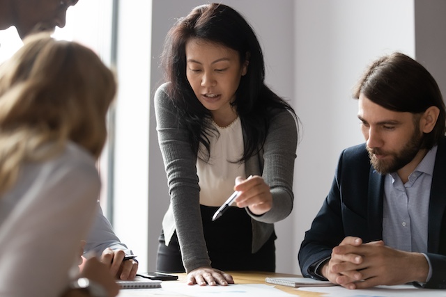 Asian female HR manager works with leadership.