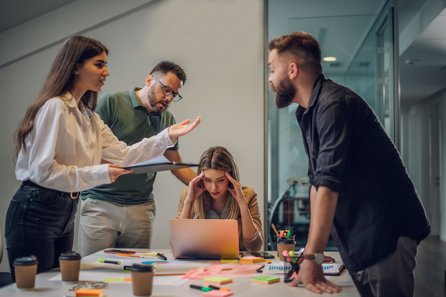 Stressed male and female coworkers work on a project