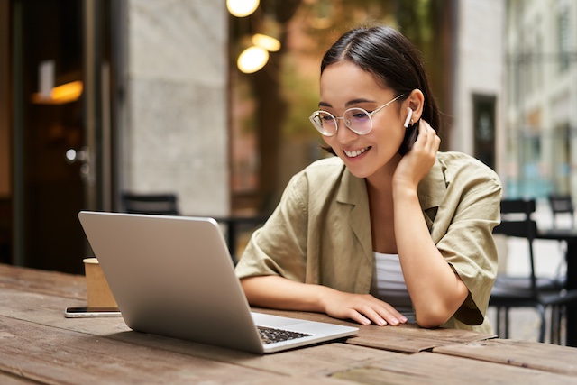 Young Asian woman on a virtual meeting on her laptop 