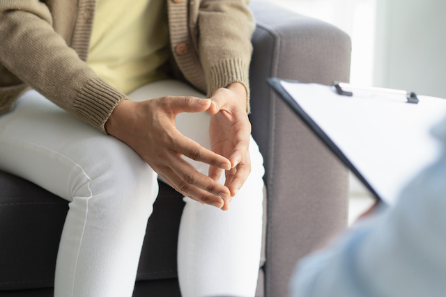 An employee speaks with a counselor at work following layoffs.