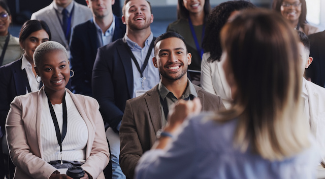 Employees listen to a speaker at a workshop