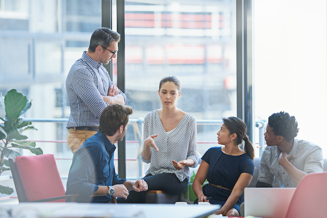 A post-merger integration team meets to discuss possible layoffs.