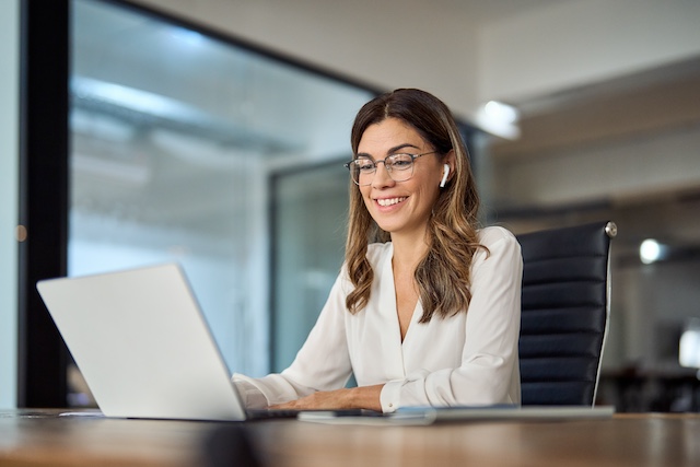 A female executive outplacement coach works with a client virtually.