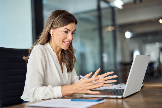 A female executive meets online with her executive coach