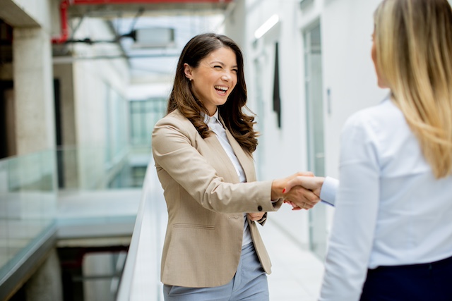 Woman with great results from her outplacement services happily accepts a job.