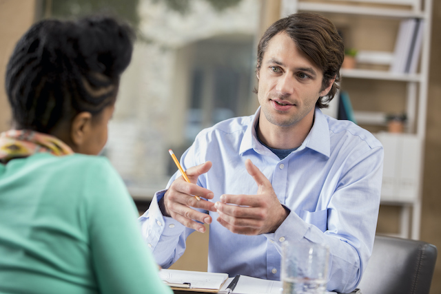 A male employee explains to his female manager why he is resigning.