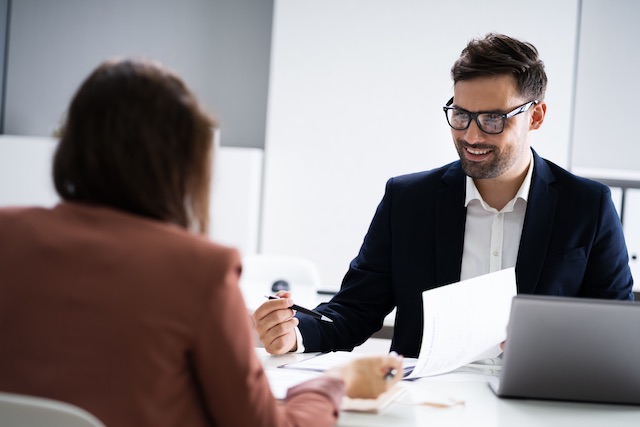 A male manager offers constructive feedback to his female employee