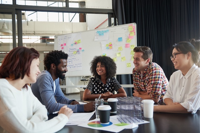 A team of web developers collaborate during a meeting