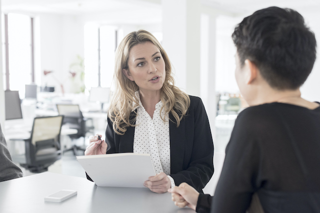 a manager talking to an employee in a modern office