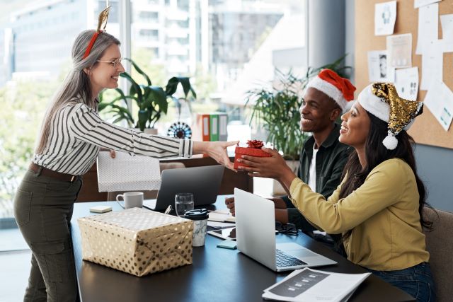 A young Black woman leads her team in a project meeting