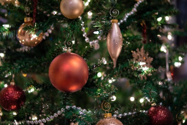 ornaments from a company team building activity hanging on a Christmas Tree