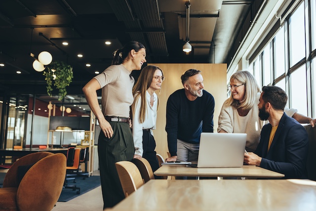 A team of men and women collaborate on a project.