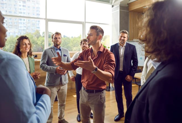 Company CEO teaching leadership communicating skills while employees actively listen