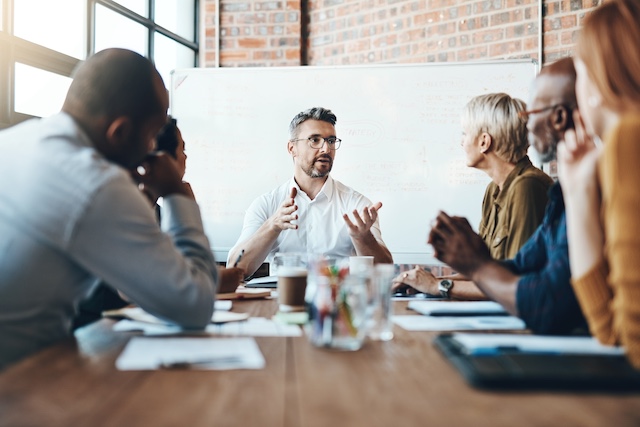 A team of department leaders meet to discuss performance review calibration.