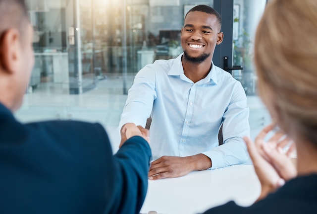 A young Black woman leads her team in a project meeting