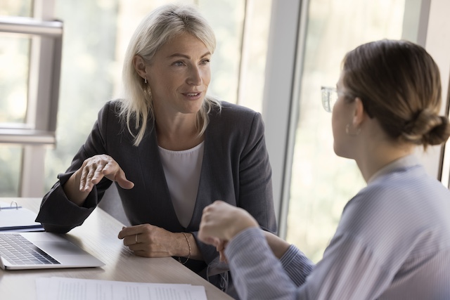 A mature female manager has a career conversation with her younger female employee