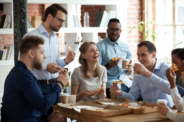 A young Black woman leads her team in a project meeting