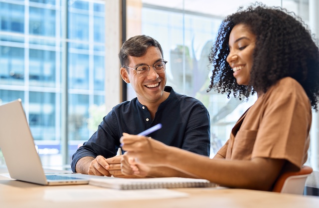 A male manager meets with a younger, African American female employee