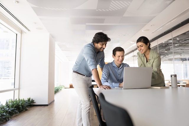 Two men and a woman collaborate at work