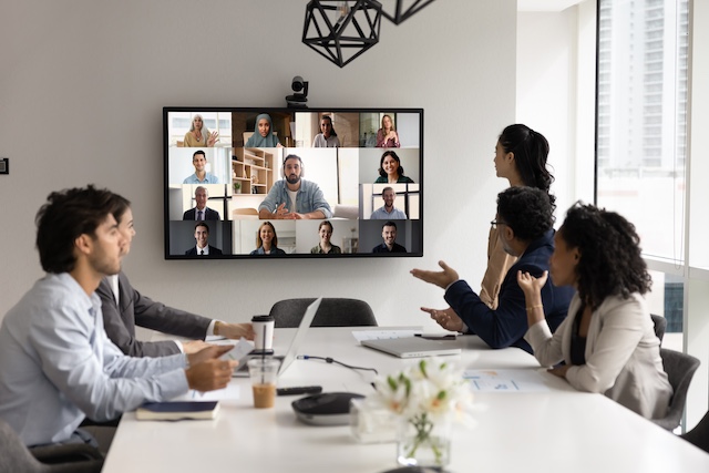 A team of businesspeople have a virtual meeting with global colleagues