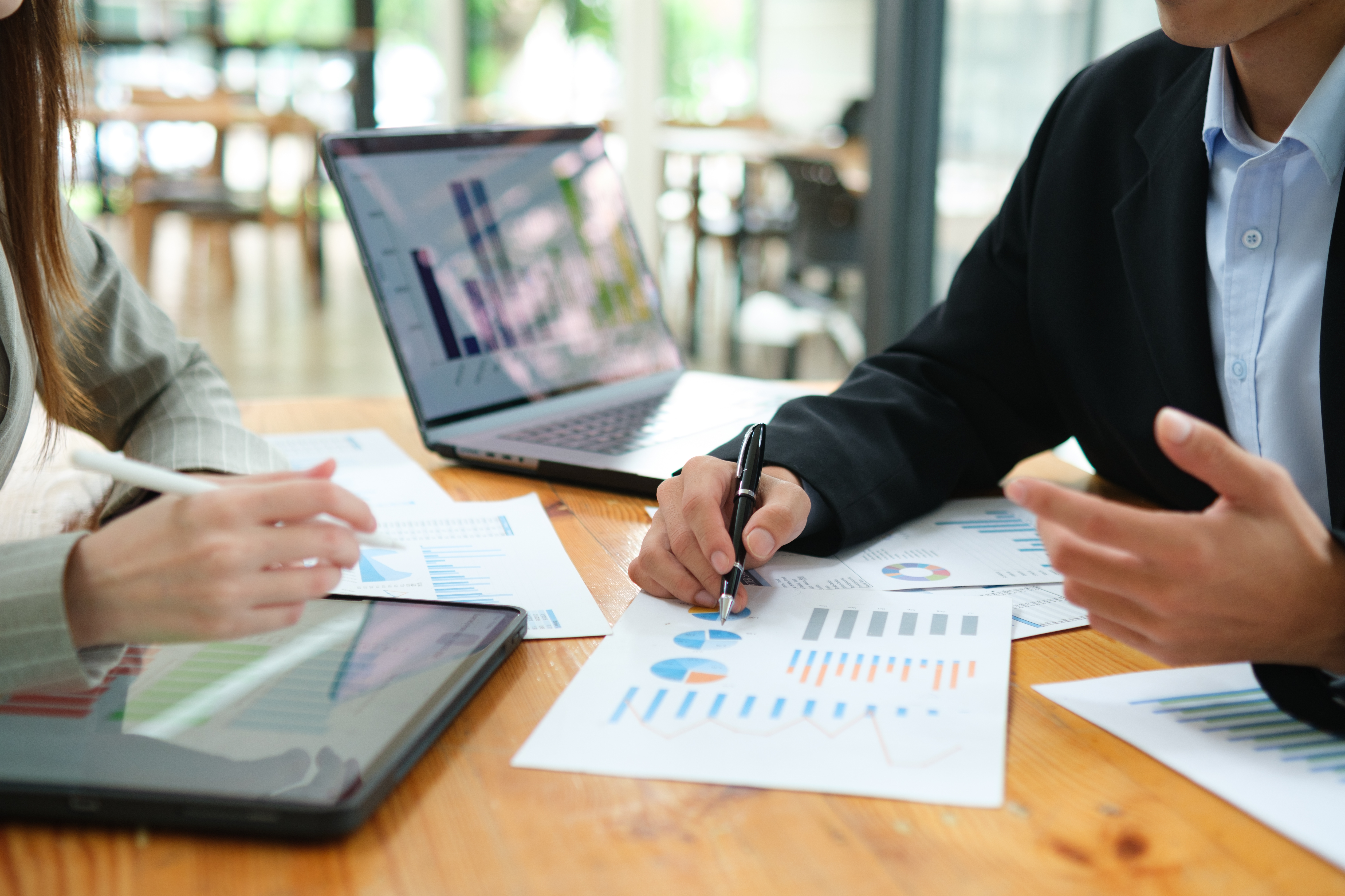 Two businesspeople meet to review finances